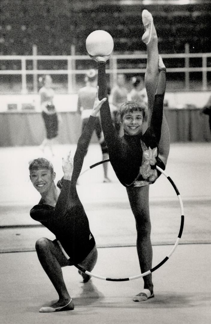 Tuning up for Games. Canadians Lori Fung, left, and Mary Fuzesi pose yesterday during practice for Four Continents Rhythmic Gymnastics Championships at Varsity Arena