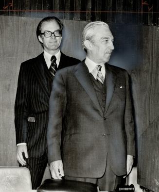 Sun life president Thomas Galt (left) and board chairman Alistair Campbell leave policyholders' meeting in Toronto yesterday during vote on moving com(...)