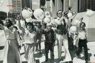 CA-NA-DA Pied Piper Bobby Gimby arrives at Bloor and Yonge Sts yesterday with 50 school children who headed south on Yonge from Asquith Ave. with flag(...)