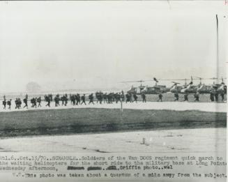 On the move to montreal soldiers of the Van Doos regiment quick-march to a line of helicopters waiting to airlift them to guard duty in the Montreal a(...)