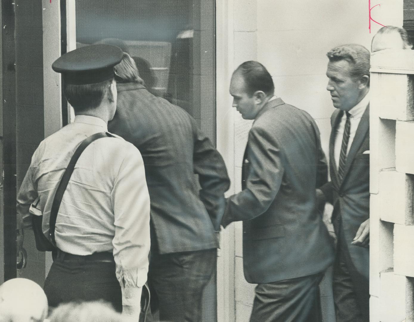 Accused kidnappers: A uniformed policeman escorts Ralph Cameron, left, and kidnap victim's former boyfriend, Gary Adams, into Whitby court today aided by a plainclothes detective