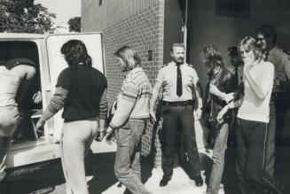 Drug bust: Some of the 13 who were arrested yesterday in a drug bust in Collingwood are led into police wagon