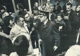 Newsmen crowd around police at Toronto Airport terminal early today after Southern Airways DC-9 jetliner was hijacked by three men and forced to fly t(...)