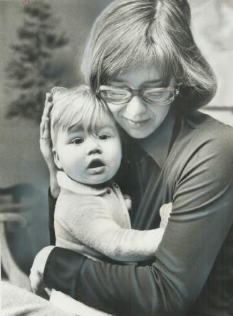 Saved from blazing North York house by a school bus driver, 8-month-old Sarah is comforted by her mother, Mrs