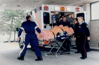 The aftermath: A shooting victim is wheeled into Sunnybrook Health Science Centre yesterday after he was hit outside a North York housing unit