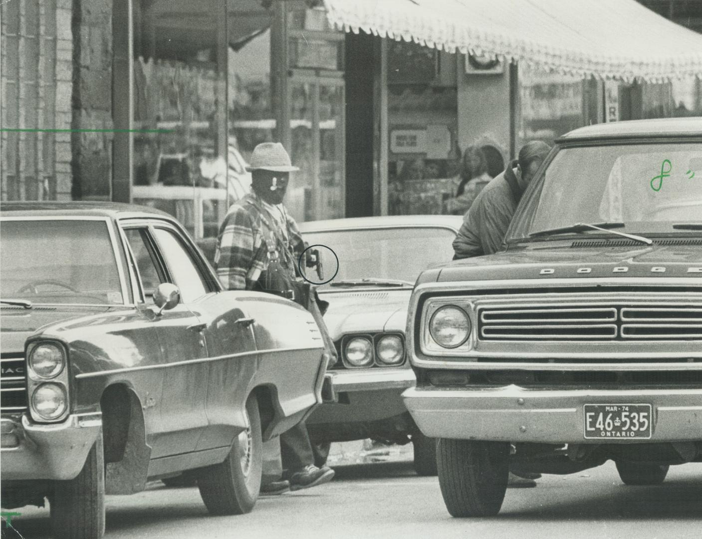 Seconds before death: Masked bandit, holding a gun in his left hand, was blown apart by dynamite on his belt