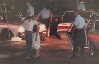 Ordeal Ends: An employee gets a hug following a robbery and hostage-taking at a Thornhill bank last night