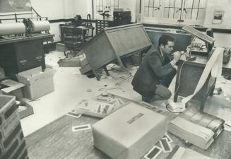 Church office Ransacked, George Buffett of the police fingerprint department looks for prints in the office of Jarvis Street Baptist Church yesterday while services go on