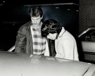 Pregnant wife: Marilyn Bacon, the wounded constable's wife, arrives at Wellesley Hospital early today with a family friend about a half-hour before her husband was taken out of surgery