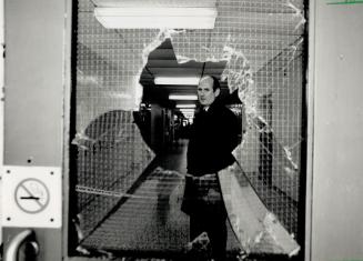 Police presence: Through a shattered window, an investigator is seen in the hall where the shooting took place