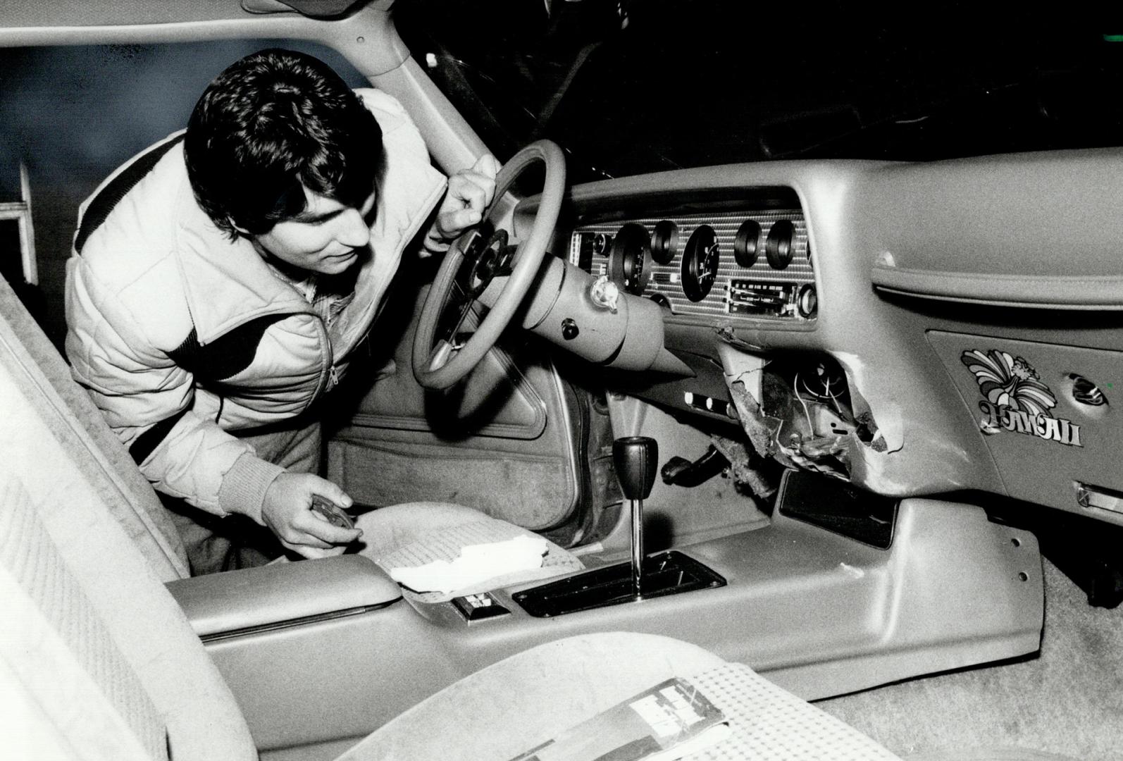 Gutted: Nick Delov looks sorrowfully at the ripped-out interior of his 1979 Trans Am, which was stripped of wheels and other parts by thieves, who then abandoned it in Vaughan