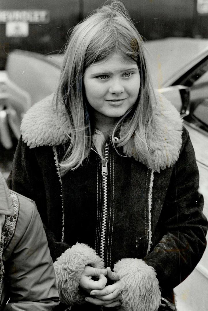 JoAnne Woodfine, 10, describes her escape from a sniper's shotgun as police examine the pellet-damaged car she was riding in and bikers wait to get back into their clubhouse