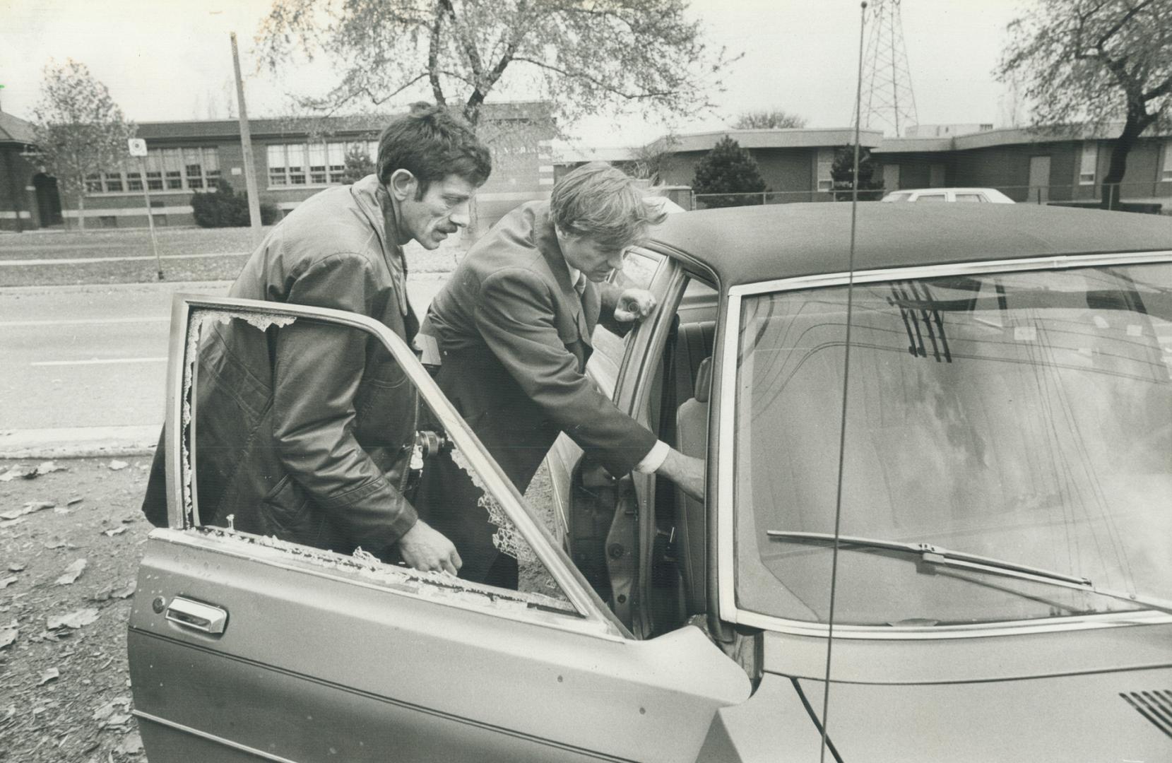 JoAnne Woodfine, 10, describes her escape from a sniper's shotgun as police examine the pellet-damaged car she was riding in and bikers wait to get back into their clubhouse