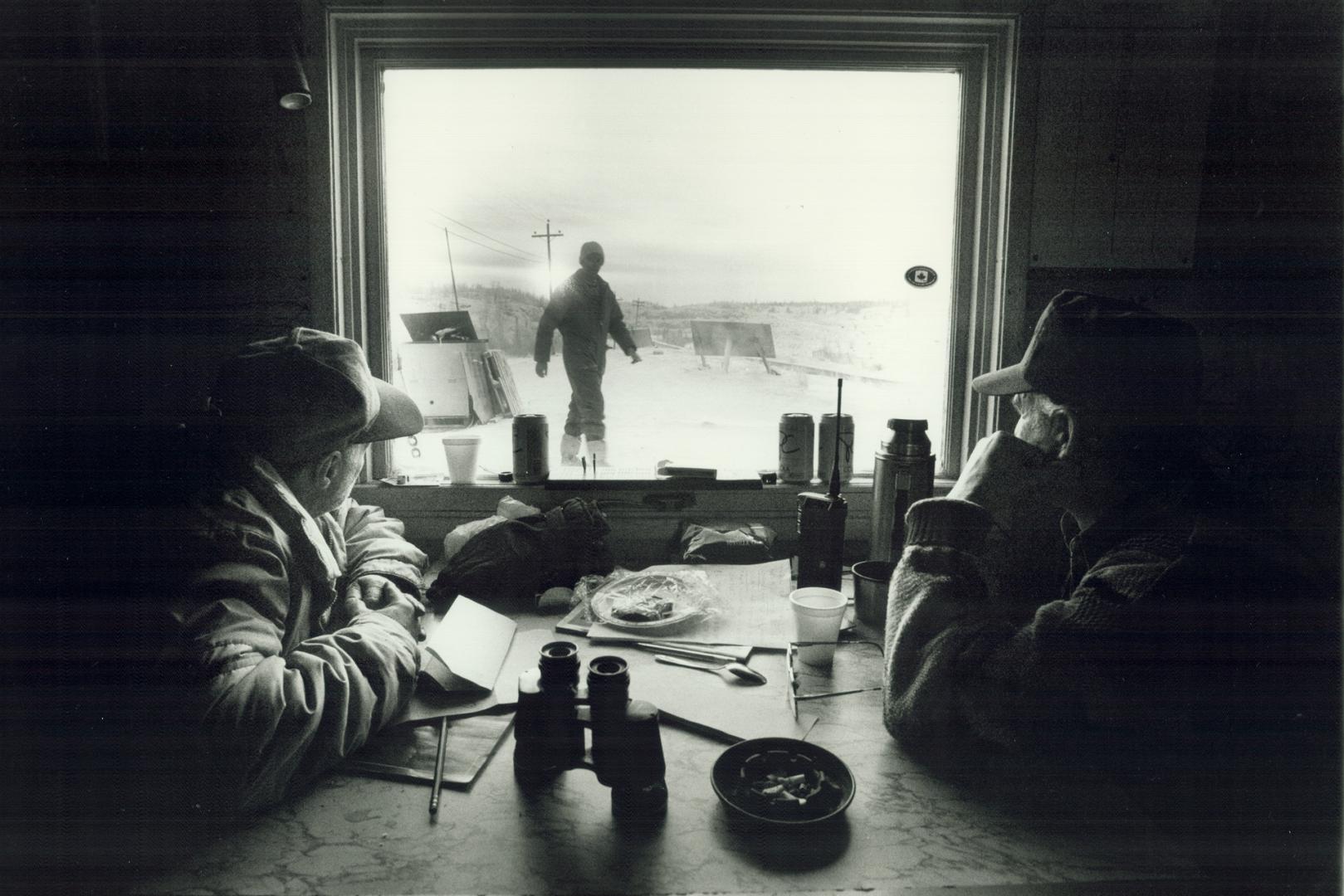 On strike: Striking miners Romeo Berube, 55, left, and Roger Warren, 49, wait in the picket line shack at Gate C, the main entrance at the Giant mine