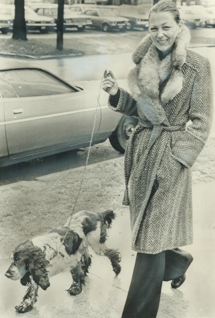 Austrian Model Marina Hundt walks Peter Demeter's dog yesterday in London, Ont