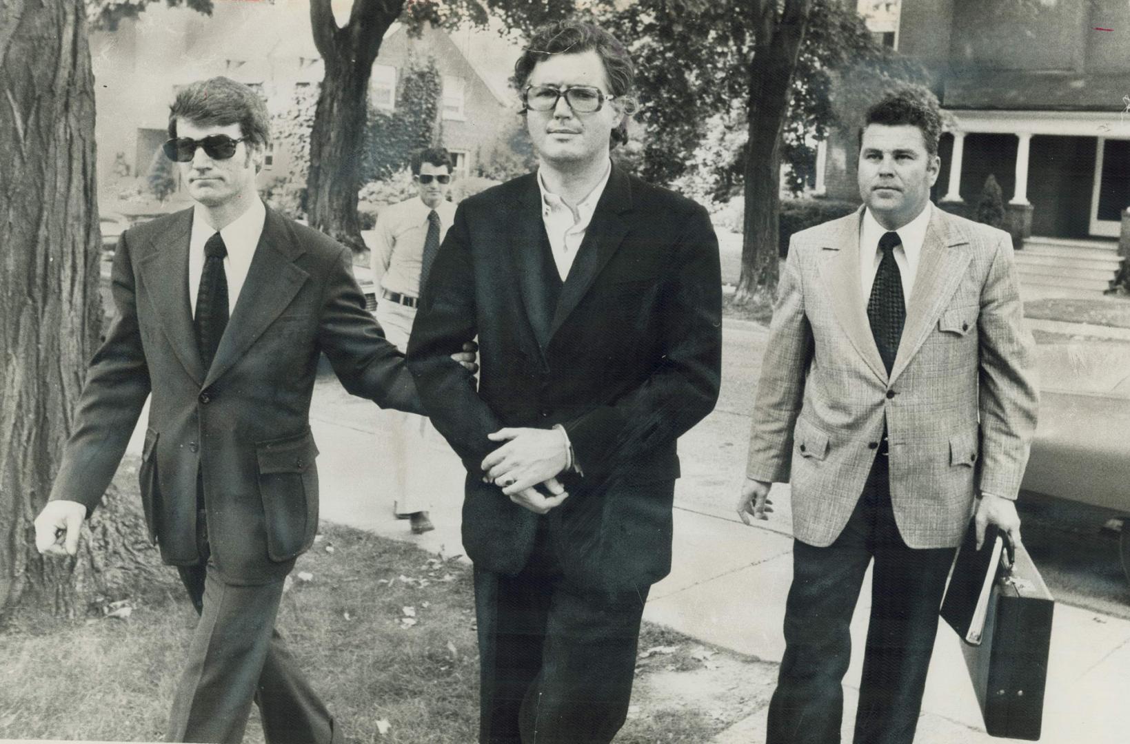 Wealthy contractor Peter Demeter (centre) is led into Brampton Jail today by Det