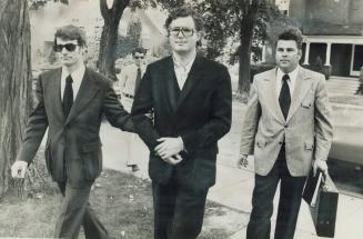 Wealthy contractor Peter Demeter (centre) is led into Brampton Jail today by Det