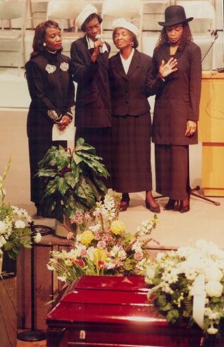 Together: Christine Ricketts' mother and sisters sing at her funeral: Jennifer Ricketts, left, Maxine Rickets, mother Gloria Nugent, and Beverley Lawrence