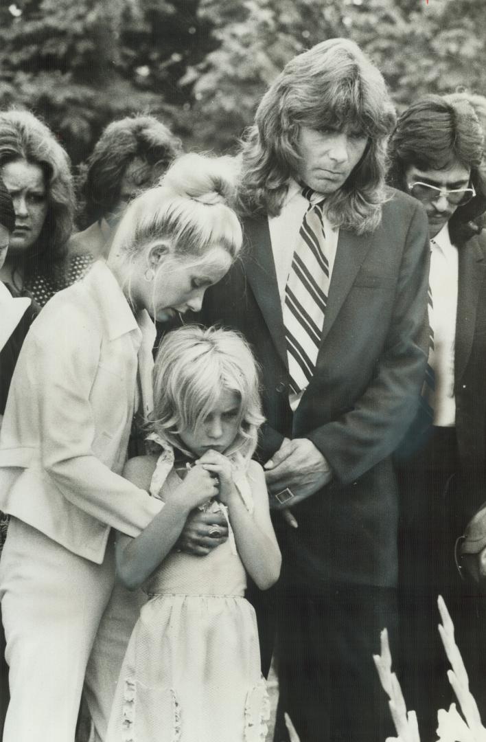 Mourning At Graveside of Kirkland Deasley are his parents, Ab and Carol Anne, and his sister, Deborah, 10