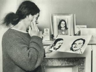 A look at the suspect: Brendan Caron, father of Sharin' Keenan, looks at a mugshot of the man police are hunting in the slaying of his daughter