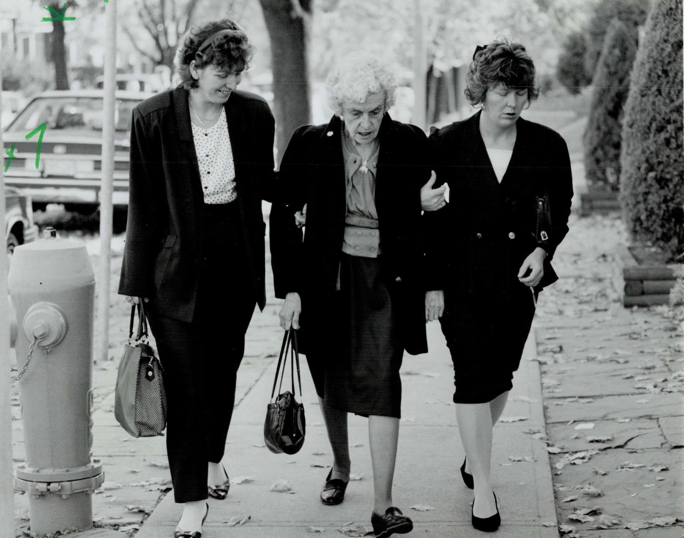 Grieving Grandmother: Ruth Windebank's mother, centre, is aided by two women outside the funeral home