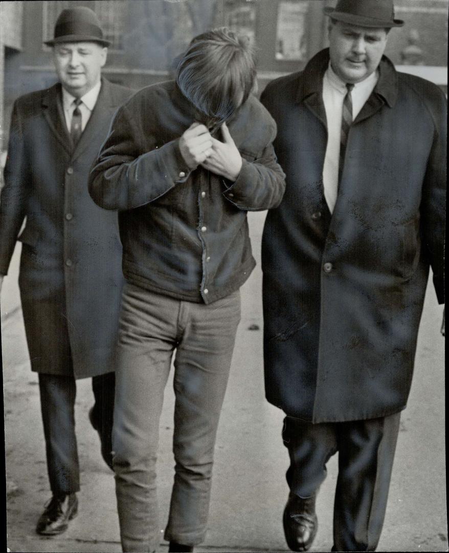 Yorkville boy on murder charge, Dennis John Whiteside (centre), 17, a Yorkville habitue arrested today by detective Jack Evans (left) and Det. Sgt. Ja(...)