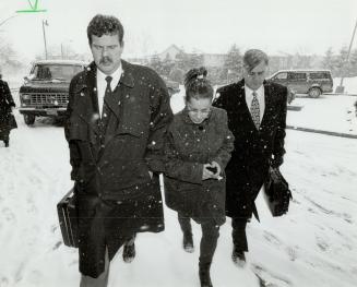 Murder Suspect: Barbara Gonsalves is escorted by Scott Bronson, left, and Jim Crowley of Metro police into her apartment, where a search was conducted