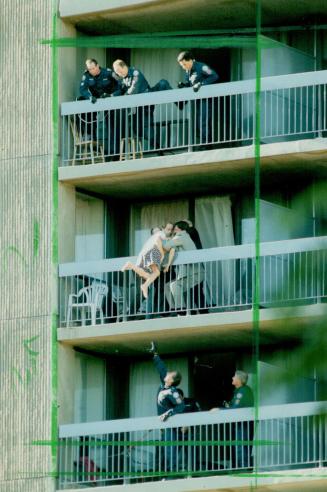 A North York woman threatening to leap off eighth-floor balcony yesterday is pulled to safety