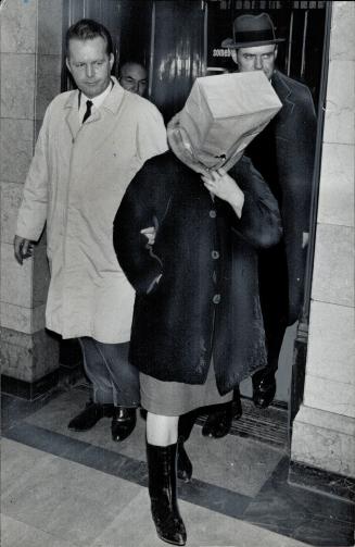 Escorted by Dets. Eric Rowe (left) and Patrick Keere, Eileen Charity Griffiths, 20 alias Smith, is shown in police headquarters yesterday. She is char(...)