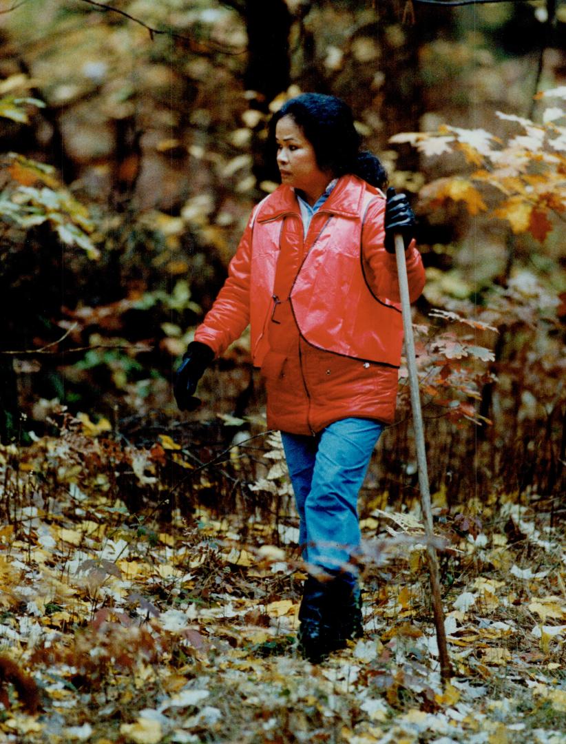 Julita Bain, above, whose daughter Elizabeth, 23, left, disappeared June 19, hikes through the Ganaraska Forest in search of clues. About 70 volunteer(...)