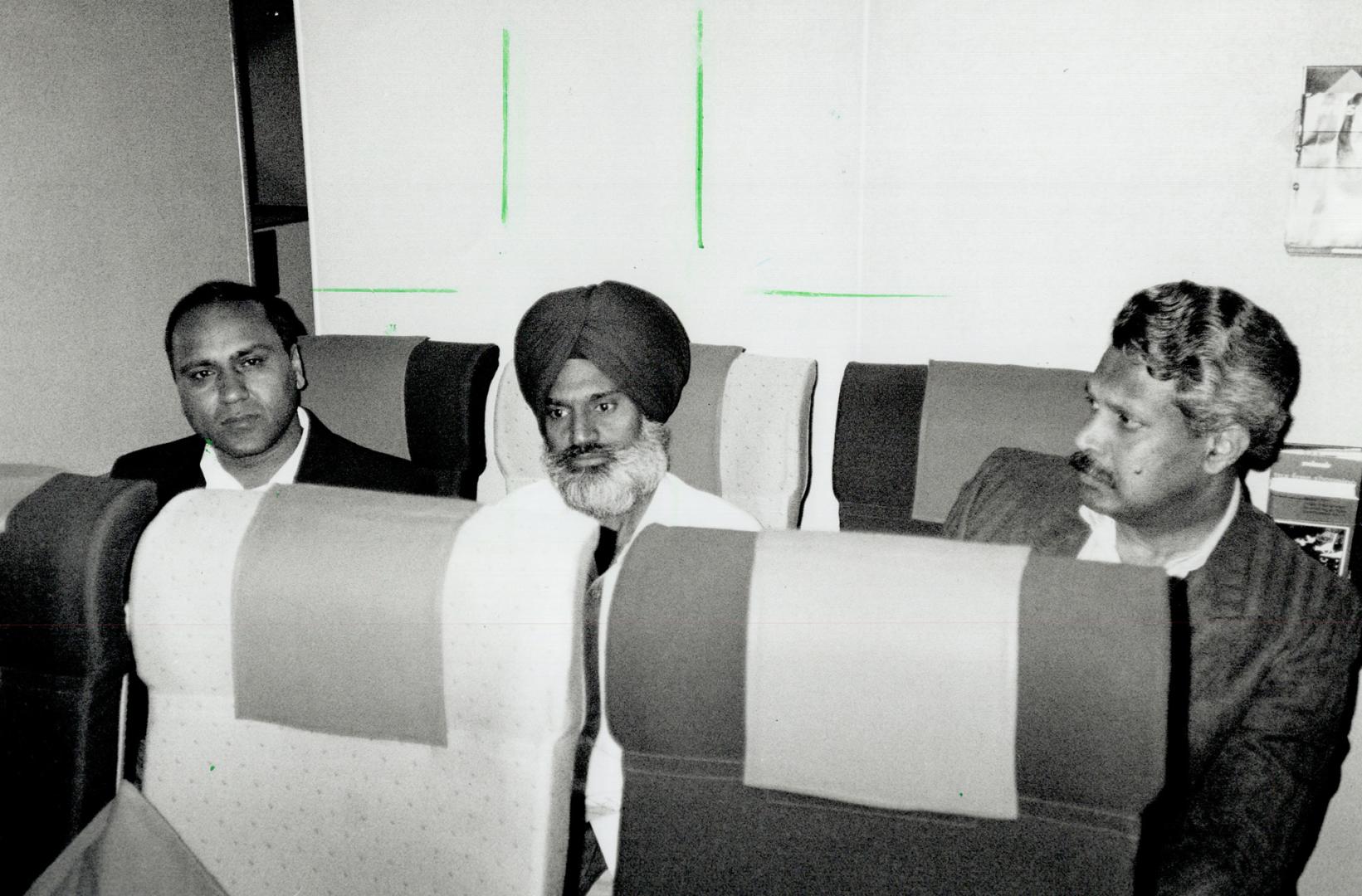 Homeward Bound: Accused Kuldip Singh Samra, 45, is flanked on flight to Toronto yesterday by Metro police Detectives Rajinder Sidhu, left, and Jake Poranganel