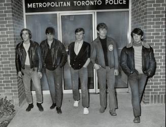 Their friend was killed: Members of a floor hockey team coached by Constable David Goldsworthy leave 31 division headquarters last night after they found out time for policeman's funeral