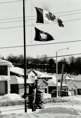 Flag lowered: Fred Willis, care-taker at the school Rajesh attended, prepares to put the Canadian flag at half-mast