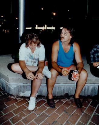 Tense wait: Kayla Klaudusz's parents, Keri Deon and Steve Klaudusz, wait outside 52 Division last night before learning a reported sighting was false