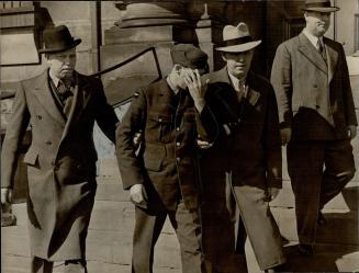 Mrs. Aune Newall, At Centre, Aircraftman Hugh A. Newall, husband of the slain woman, leaves Don Jail under police escort to attend the service