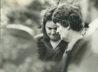 Bearing up: Mother Diane Tomlinson, left, leans on another woman for support as four pallbearers carried the tiny coffin of her youngest daughter, Lizzie, 6, to the grave yesterday