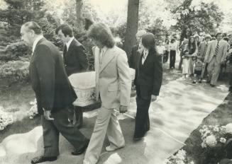 Pallbearers carry the coffin of murder victim Lizzie Tomlinson