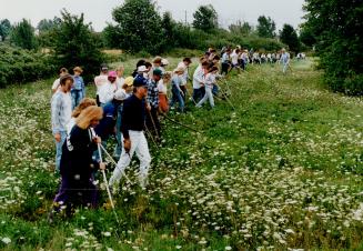 Through Job: A group of 50 volunteers, led by an off-duty police officers working without pay, scours the alloted area seeking clues