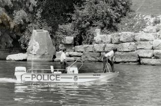 HUnt continues: Police Constables Shane Crawford, left, and Kim Duncan search the Burlington shoreline yesterday for clues in the disappearance last Friday of Nina DeVilliers, 18