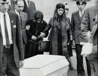 A mother's Grief is expressed by Mrs. Rasim Taka (head bowed), who said she would not attend the funeral of her slain daughter, Debbie, as she was pre(...)