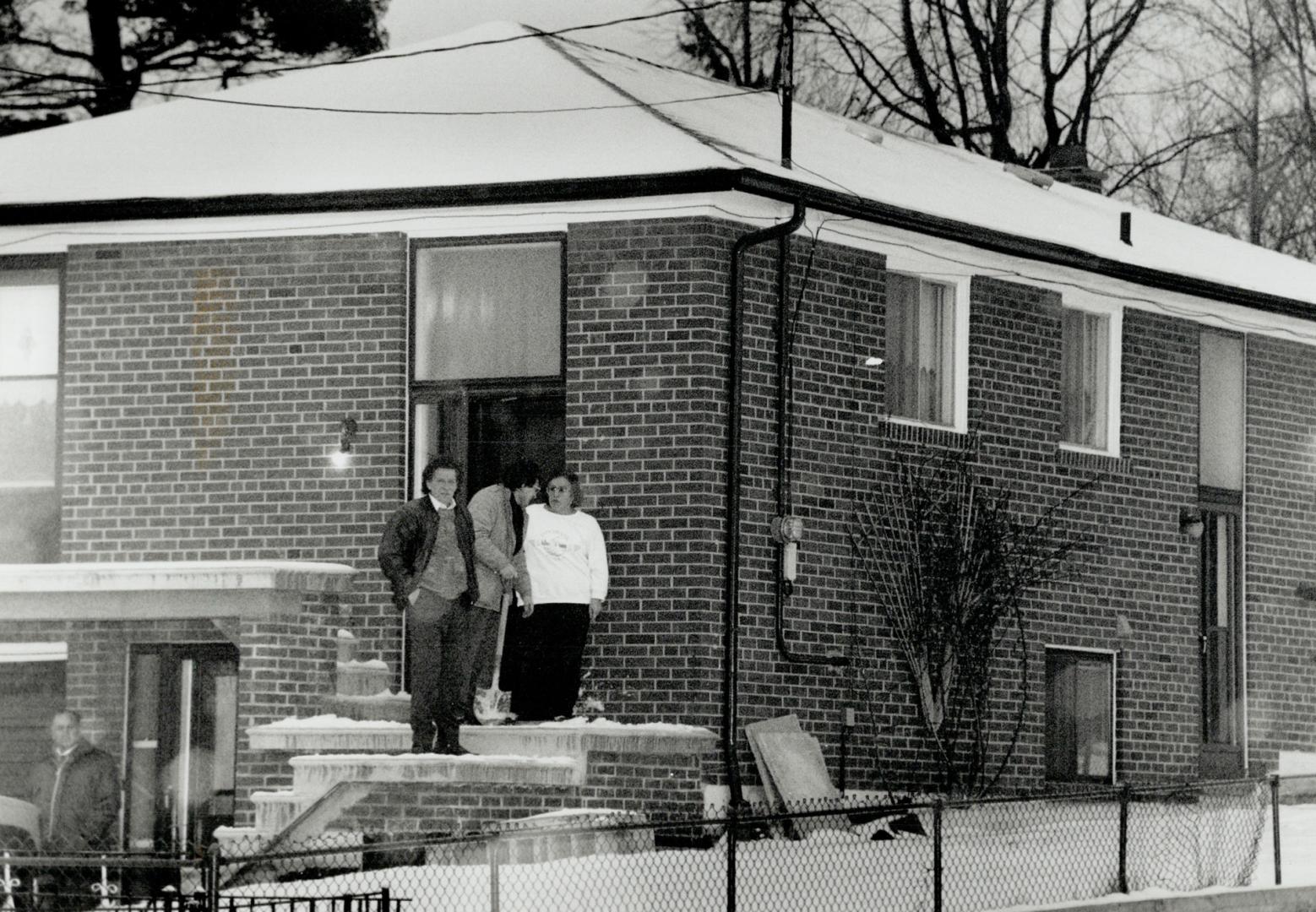 Shocked: Brother-in-law John Maniaci (with spade) talks to neighbor George Pappas and a female family member today outside Drago's home