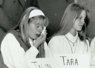 Friends weep: A friend and Grade 10 schoolmate of abducted Kristen French sheds tears at a news conference held by Holy Cross Separate School yesterday