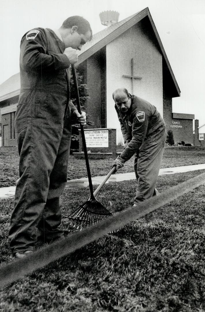 Seeking clues: Investigators search the lawns around Grace Lutheran Church looking for clues in the abduction and disappearance of Kristen Dawn French