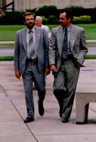 Private chat: Dan Mahaffy, left, walks around the courthouse with lead police investigator Vince Bevan