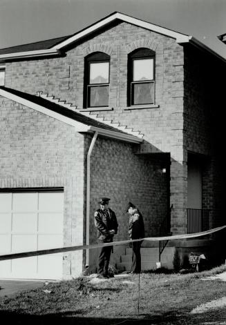 Slaying scene: York Region police guard the home of Alfred Lobo who was stabbed to death by an intruder