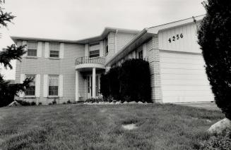 Murder scene: Mississauga hairstylist Cosimo Lombardo, 49, died on the driveway of his Marblethorne Court home (above) early yesterday after being hit by a hall of gunfire