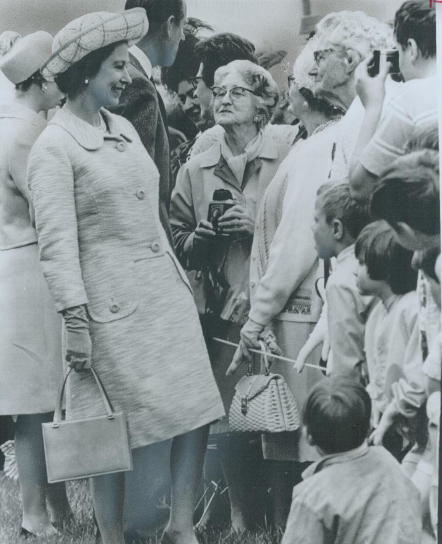 Administration Glows on the face of Mrs. Edith Gormley, 72, as she beams at the Queen in Fort Steele, B.C. Provincial Secretary Wesley Black, in a spe(...)