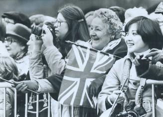 Ceremantina Whiteside (behind flag) and Marilyn Jackson (right), of Toronto, enjoyed the game