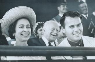 The Queen, Governor-General Roland Michener and Tourism Minister Claude Bennett watch a brief program in the forum at Ontario Place