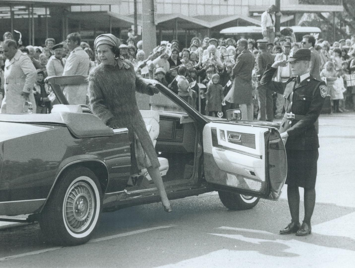 Arrival in Cornwall: As 2,000 very cold but excited residents cheer, Queen Elizabeth steps out of the royal limousine in front of the Cornwall civic centre yesterday